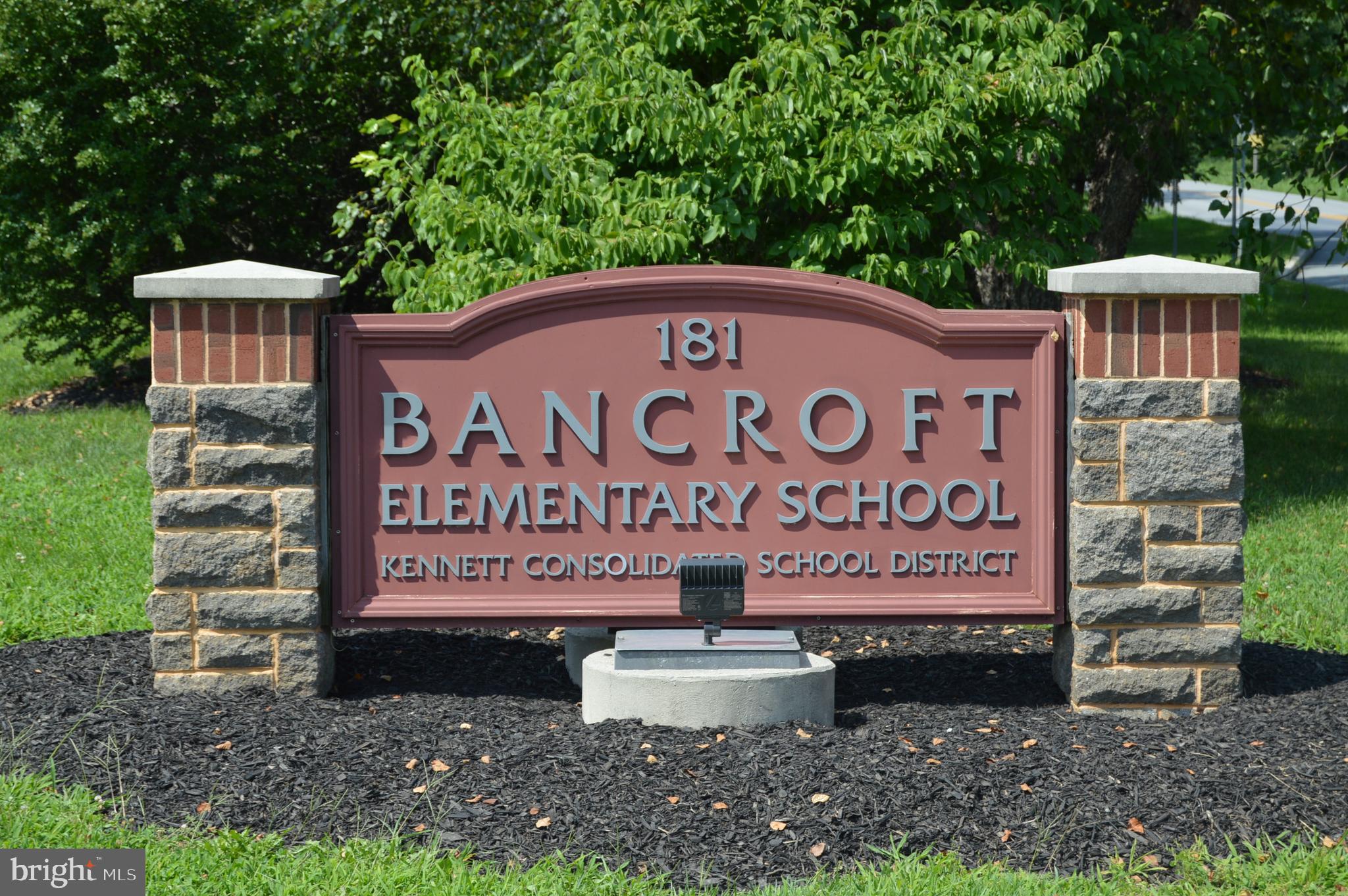 156 Bancroft Road, Unit CARLTON Kennett Square, PA 19348 - Photo 47 of 47 a sign that is sitting on a brick wall
