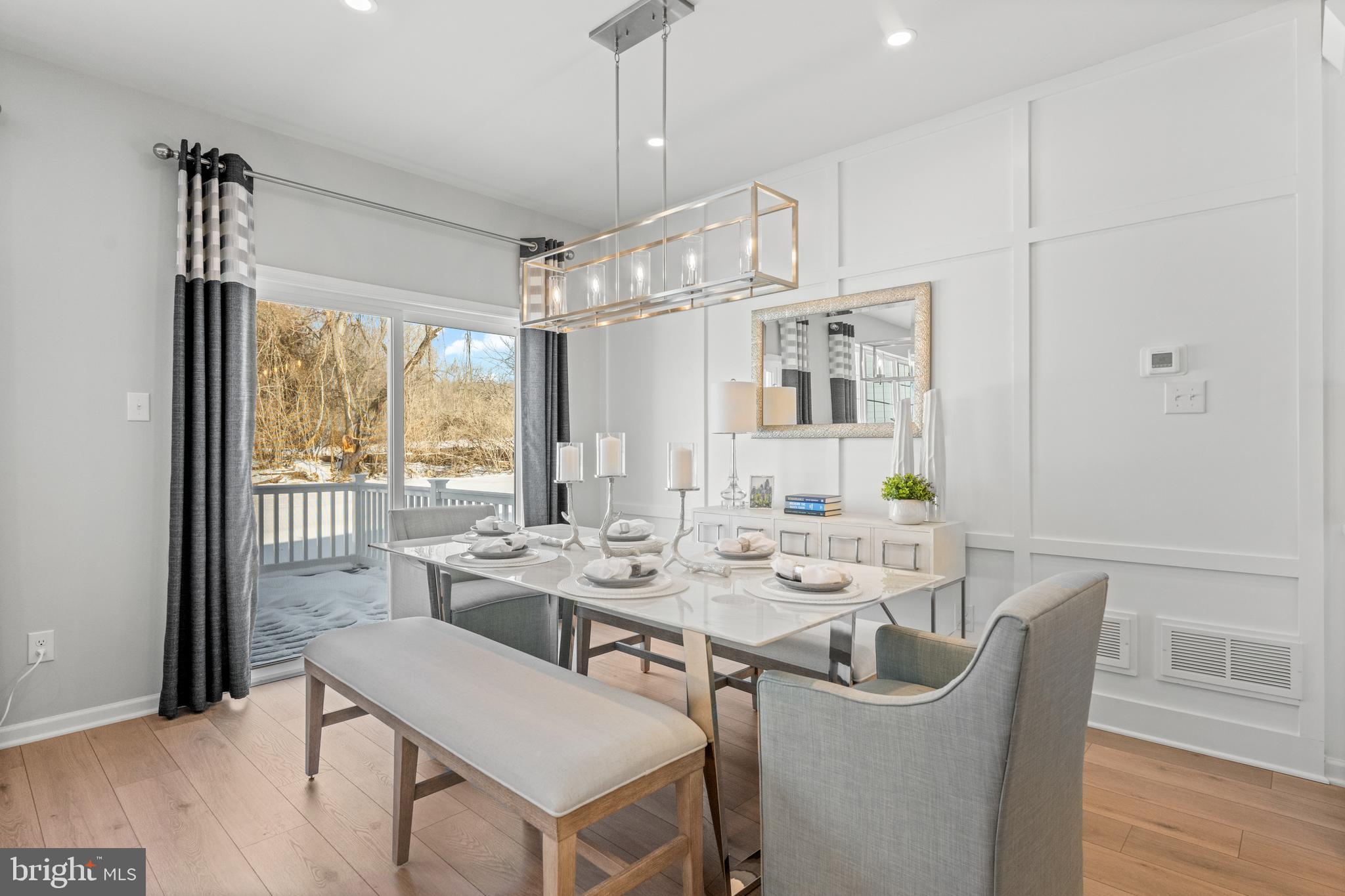 156 Bancroft Road, Unit CARLTON Kennett Square, PA 19348 - Photo 6 of 47 a view of a dining room with furniture window and wooden floor
