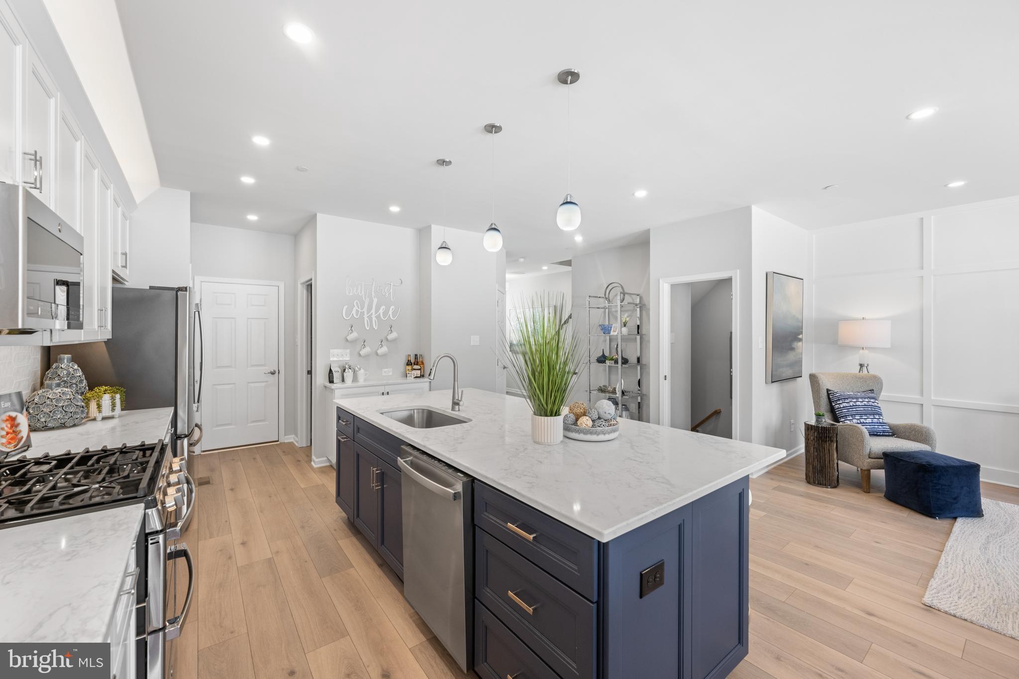 156 Bancroft Road, Unit CARLTON Kennett Square, PA 19348 - Photo 9 of 47 a large kitchen with kitchen island a sink stove and refrigerator