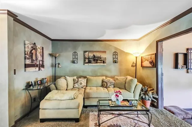 a living room with furniture and painting on the wall