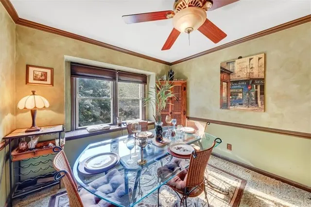 a dining room with furniture a rug and a chandelier