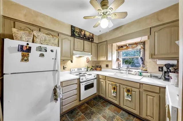 a kitchen with a white cabinets and white appliances
