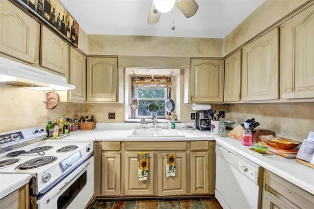 a kitchen with a sink stove and cabinets