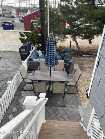 a view of a patio with couches table and chairs and potted plants