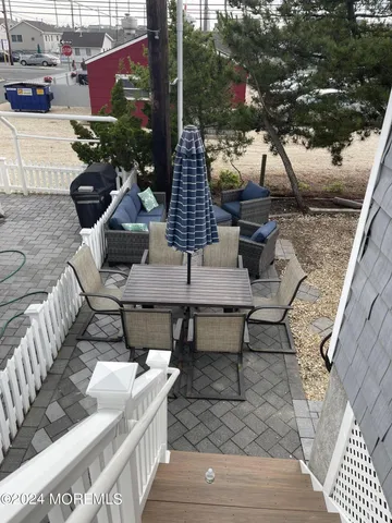 a view of a patio with couches table and chairs and potted plants
