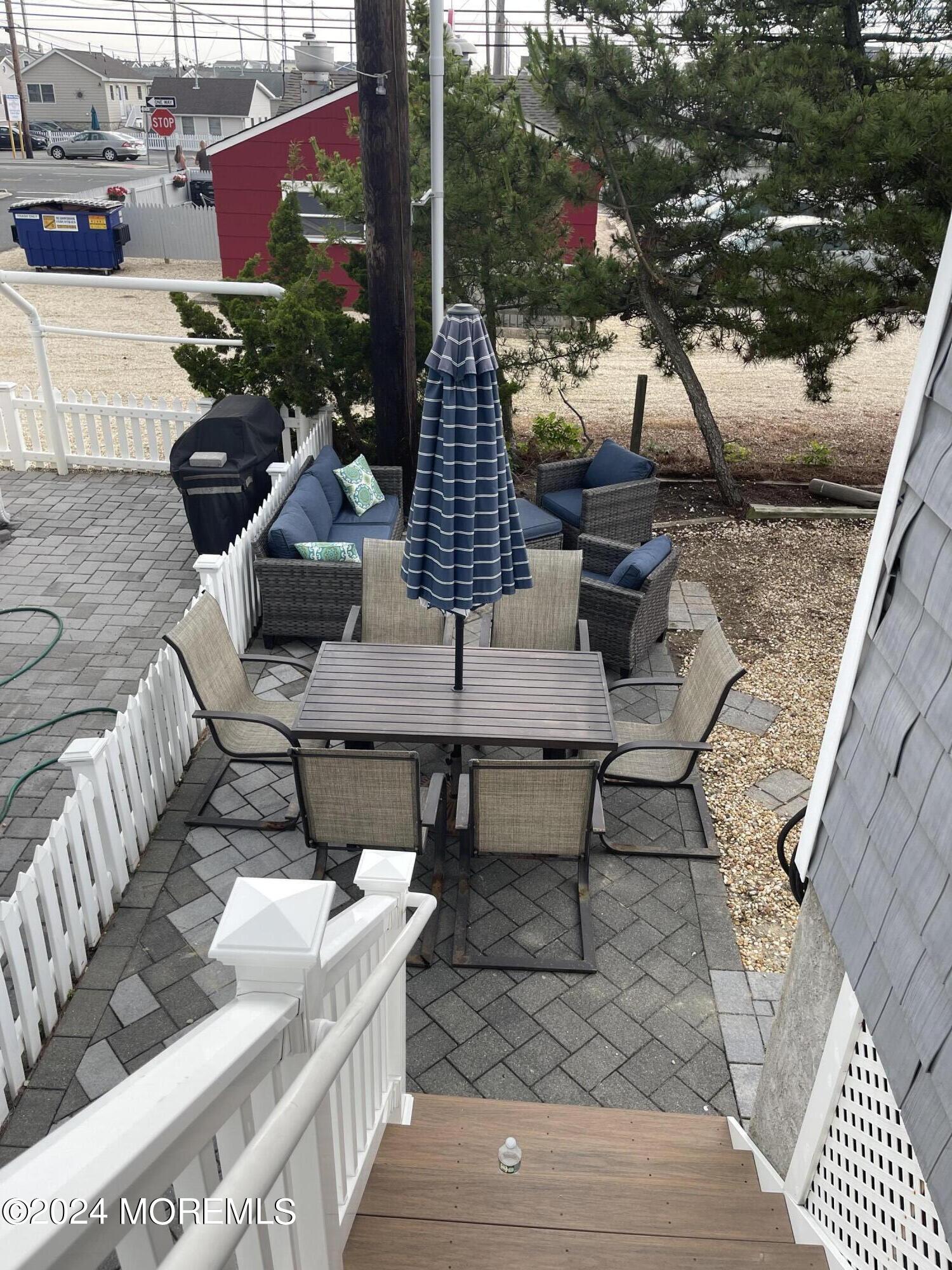 104 West Chadwick Way Lavallette, NJ 08735 - Photo 13 of 13 a view of a patio with couches table and chairs and potted plants