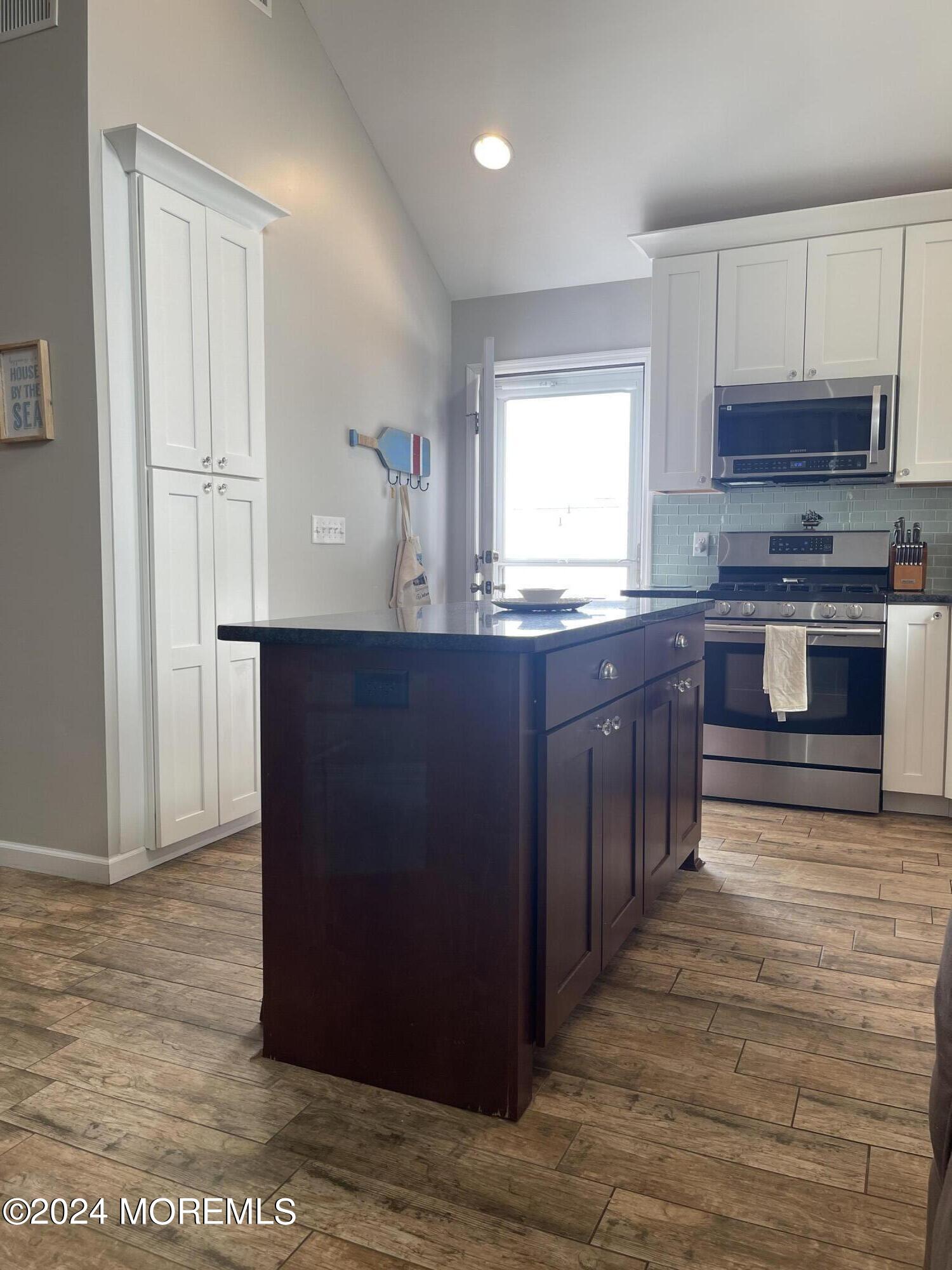 104 West Chadwick Way Lavallette, NJ 08735 - Photo 2 of 13 a kitchen with stainless steel appliances granite countertop a stove a sink and a microwave