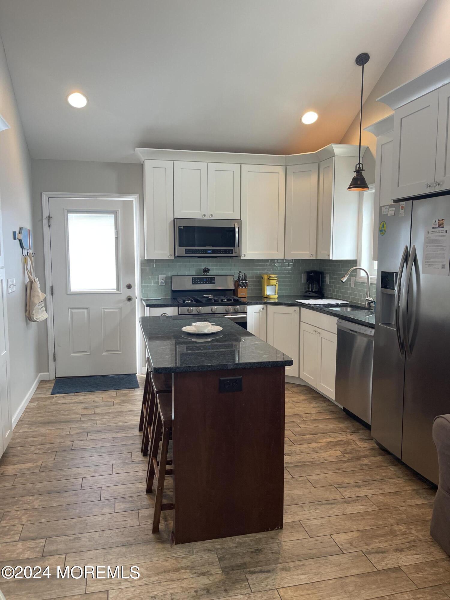 104 West Chadwick Way Lavallette, NJ 08735 - Photo 3 of 13 a kitchen with stainless steel appliances granite countertop a stove a sink dishwasher a refrigerator and a microwave