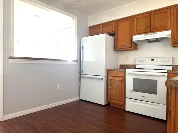 a white refrigerator freezer sitting inside of a kitchen