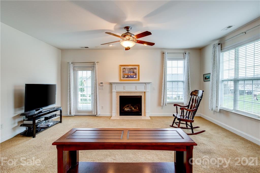 291 Garnet Court Fort Mill, SC 29708 - Photo 14 of 30 a living room with furniture a fireplace and a flat screen tv