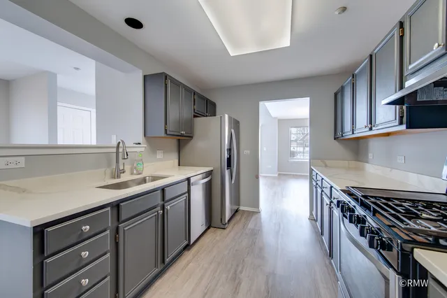 a kitchen with a sink stove and cabinets