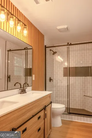 a bathroom with a sink toilet and shower