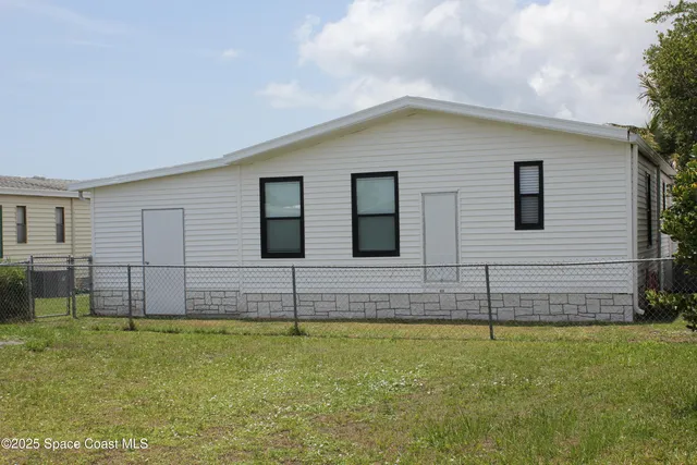 a front view of a house with plants