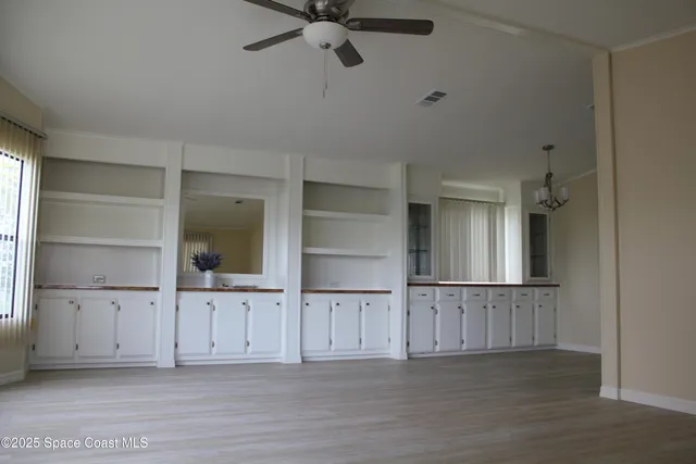 a view of kitchen with refrigerator and microwave