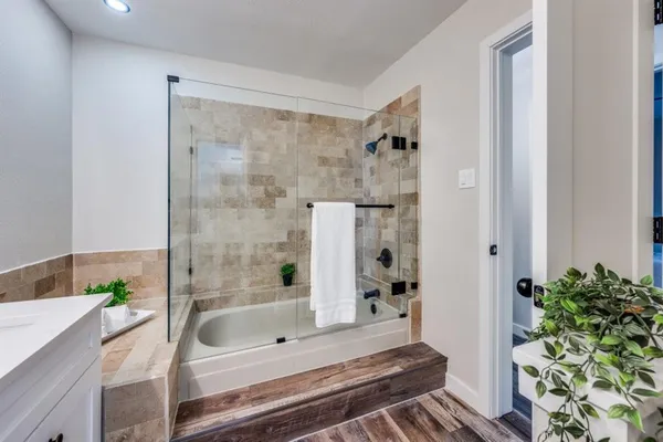 a bathroom with a bathtub and shower