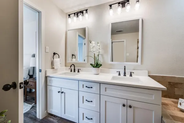 a bathroom with a double vanity sink double and mirror