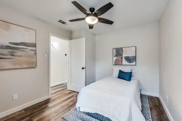 a bedroom with a bed and a painting on the wall