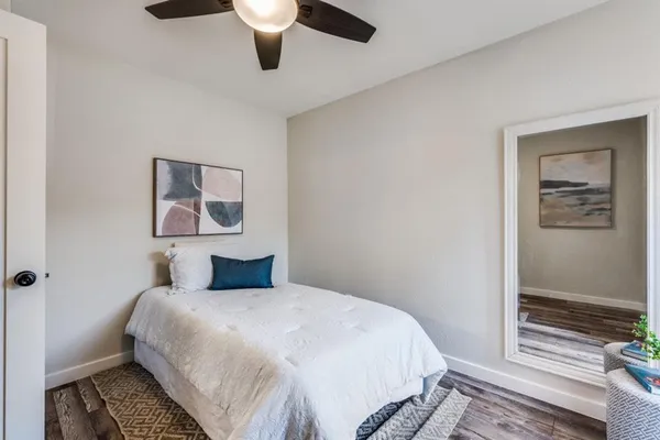 a bedroom with a bed and painting on the wall