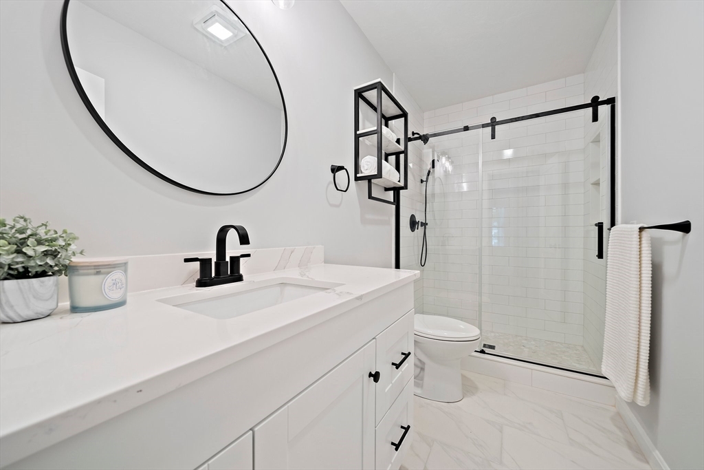192 Allerton Commons Lane, Unit 192 Braintree, MA 02184 - Photo 13 of 17 a bathroom with a sink and a mirror