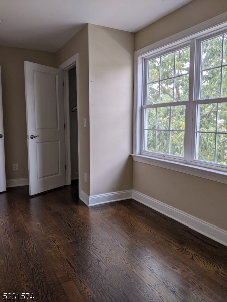 155 Locust Drive Union, NJ 07083 - Photo 12 of 24 a view of an empty room with wooden floor and a window