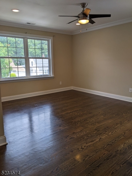 155 Locust Drive Union, NJ 07083 - Photo 13 of 24 an empty room with wooden floor chandelier fan and windows