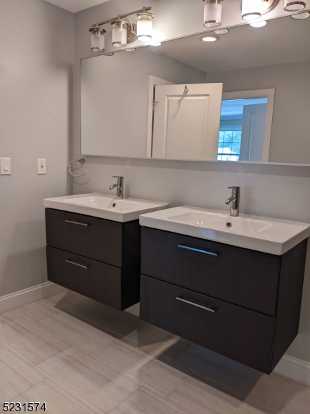 155 Locust Drive Union, NJ 07083 - Photo 20 of 24 a bathroom with a sink and a mirror