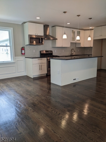 155 Locust Drive Union, NJ 07083 - Photo 3 of 24 a kitchen with stainless steel appliances kitchen island granite countertop a stove a sink and a refrigerator