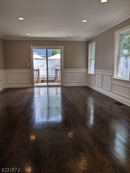 155 Locust Drive Union, NJ 07083 - Photo 5 of 24 a view of empty room with wooden floor and fan