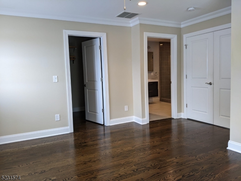 155 Locust Drive Union, NJ 07083 - Photo 7 of 24 an empty room with wooden floor & closet area