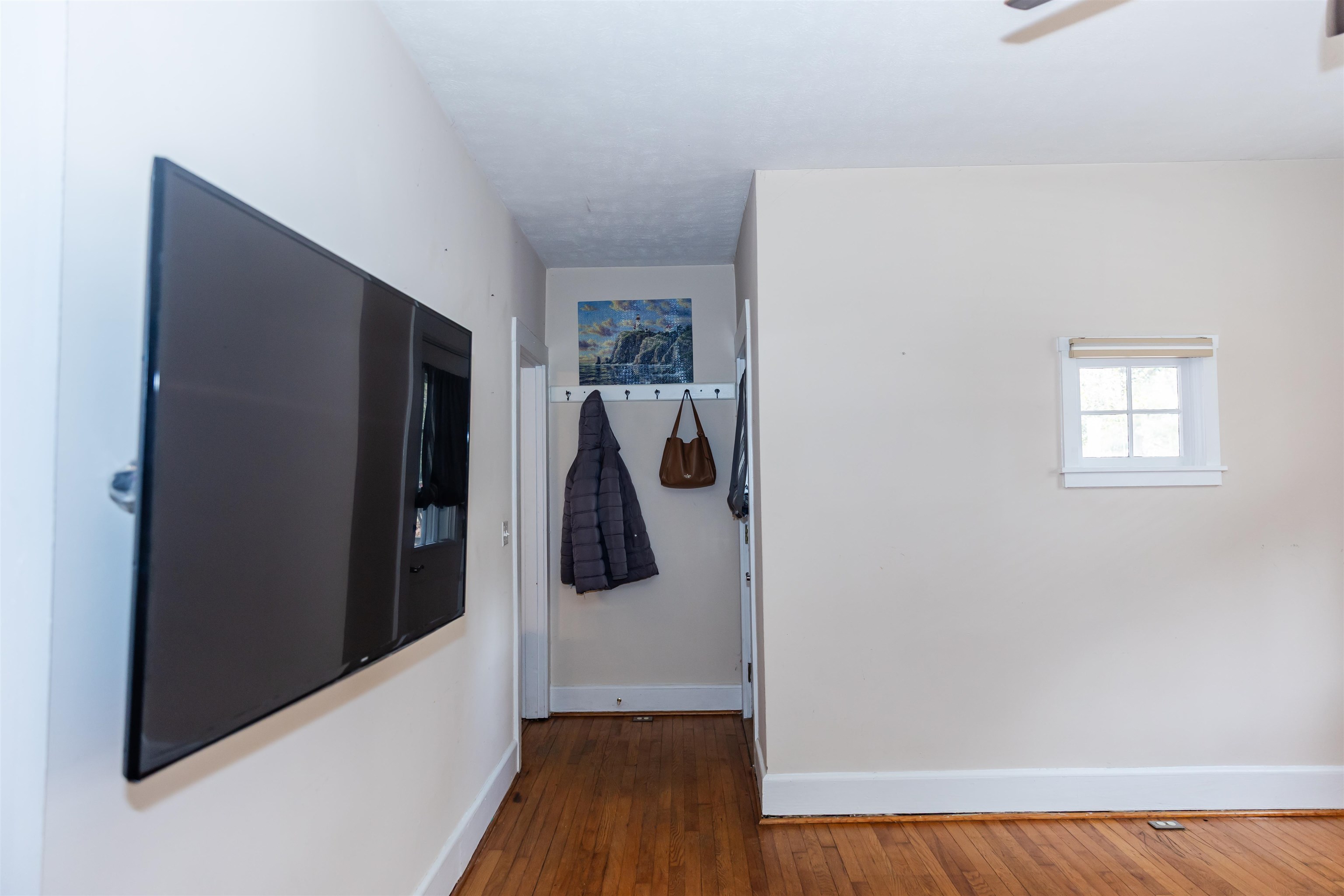 713 Thorn Hill Road Lexington, VA 24450 - Photo 16 of 45 a view of a hallway with wooden floor and a livingroom with entryway