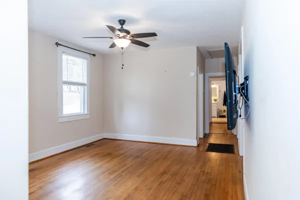 a view of a hallway with wooden floor and entryway