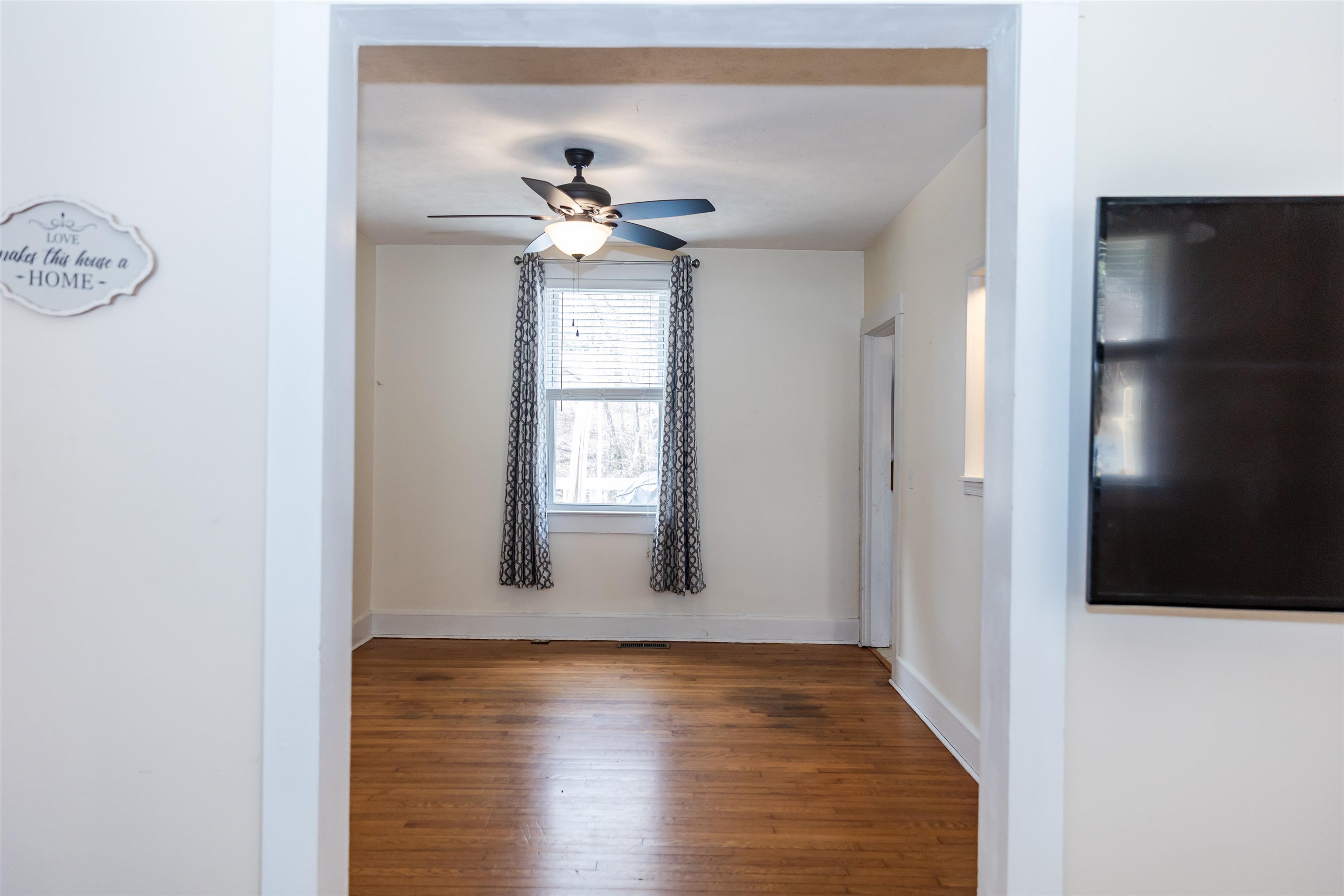 713 Thorn Hill Road Lexington, VA 24450 - Photo 18 of 45 a view of an empty room with window and wooden floor