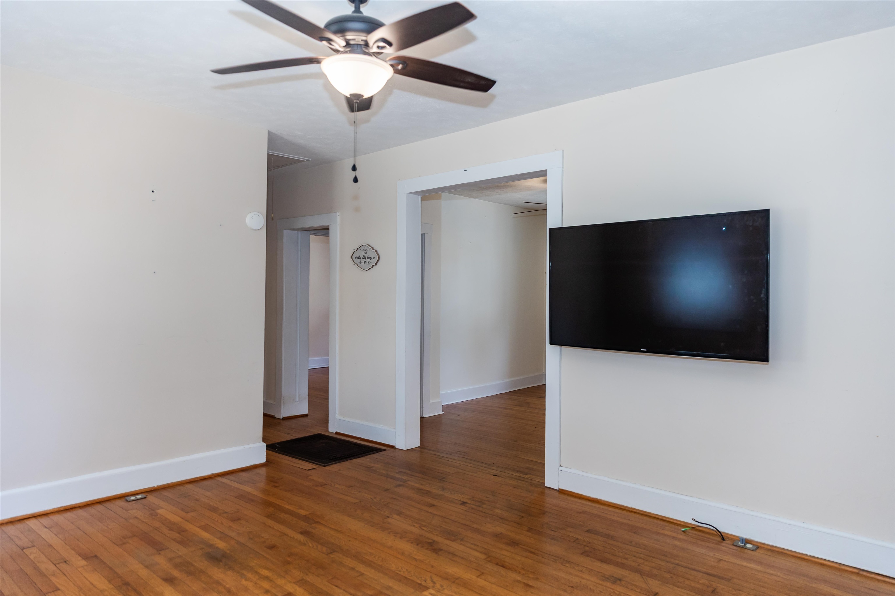 713 Thorn Hill Road Lexington, VA 24450 - Photo 19 of 45 an empty room with wooden floor fan and windows