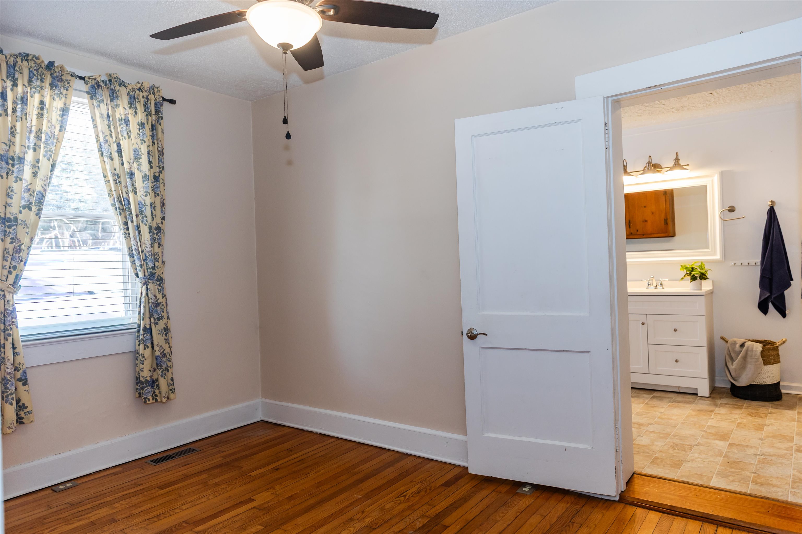 713 Thorn Hill Road Lexington, VA 24450 - Photo 23 of 45 wooden floor in an empty room with a window