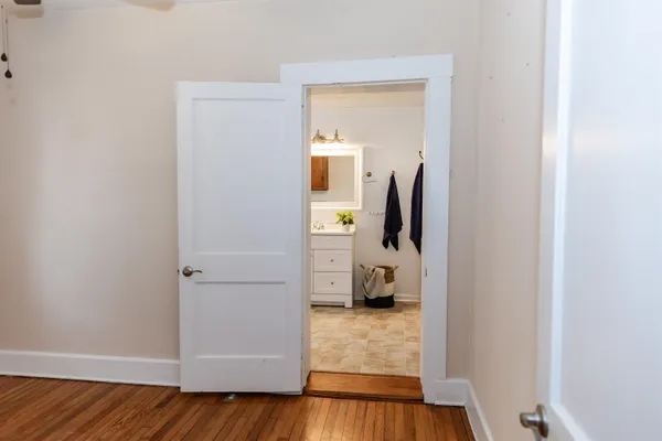 a view of walk in closet with wooden floor