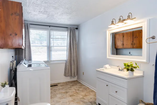 a bathroom with a sink a mirror and a window