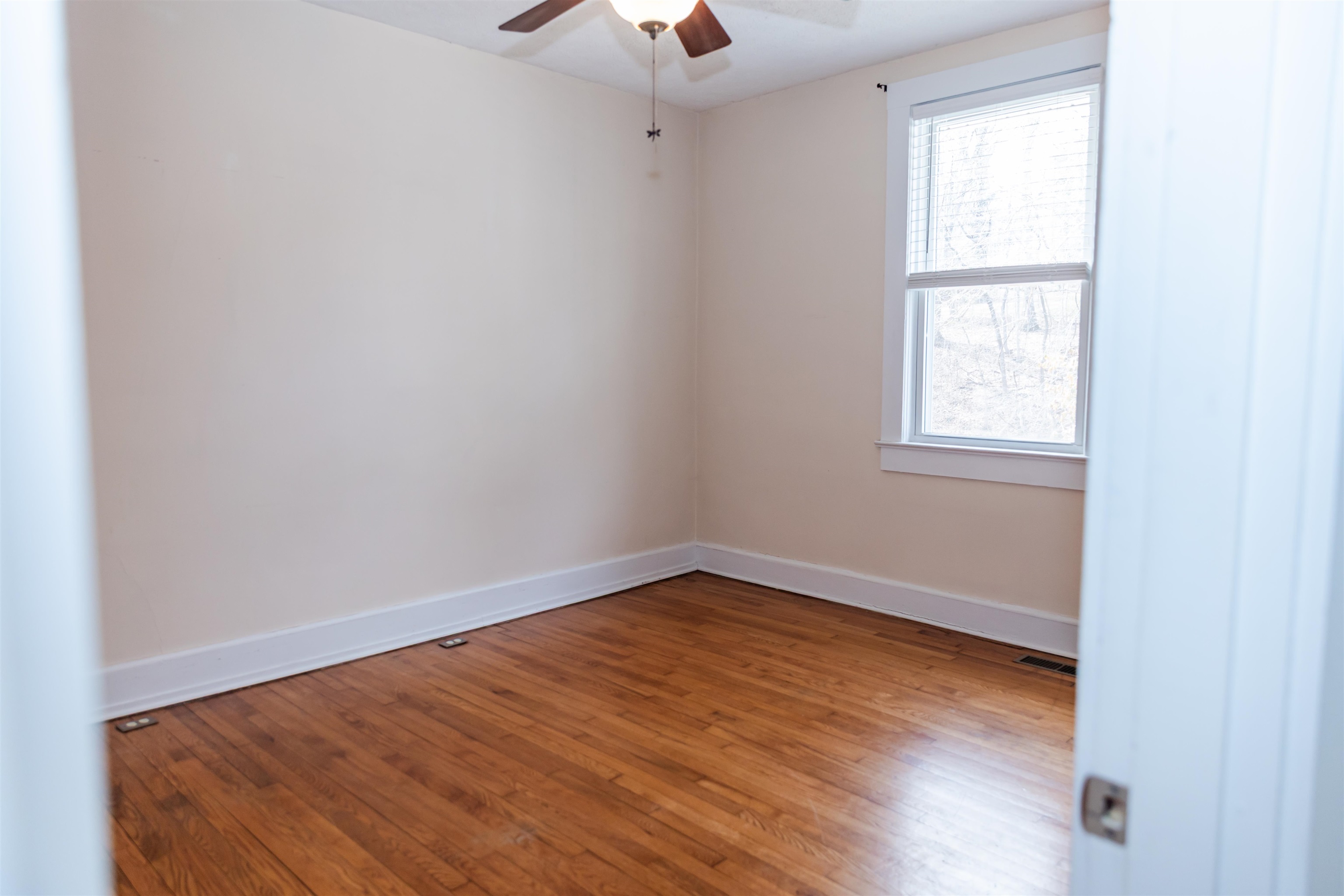 713 Thorn Hill Road Lexington, VA 24450 - Photo 33 of 45 an empty room with a window and wooden floor