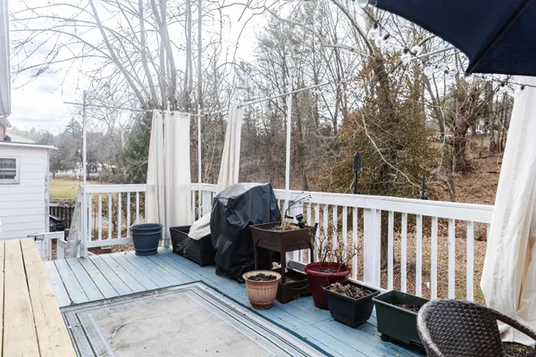 a view of a balcony with chair and wooden floor