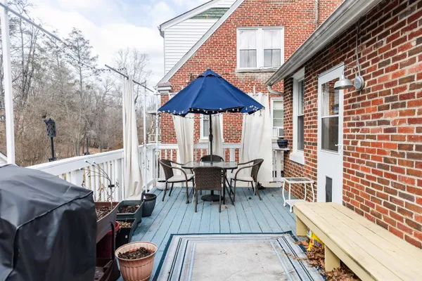 a view of deck with table and chairs wooden floor and fence