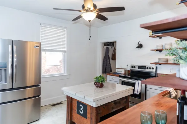 a kitchen with stainless steel appliances a stove a refrigerator and a refrigerator