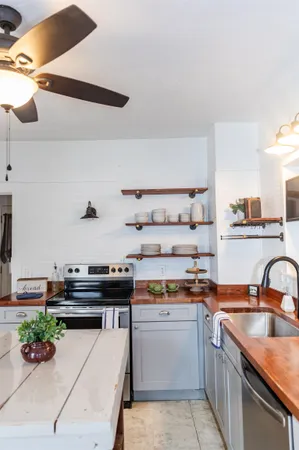 a kitchen with kitchen island stainless steel appliances a sink and stove