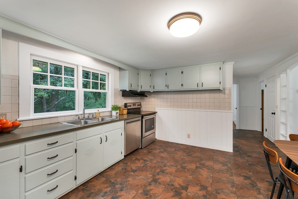 104 Kensington Road Hampton Falls, NH 03844 - Photo 20 of 42 a kitchen with granite countertop white cabinets and a stove