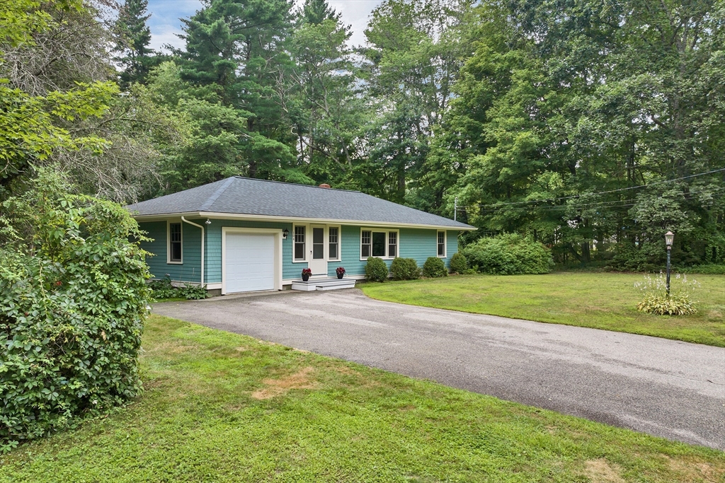 104 Kensington Road Hampton Falls, NH 03844 - Photo 2 of 42 a front view of house with yard and green space