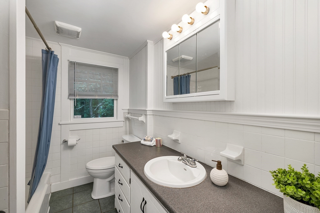 104 Kensington Road Hampton Falls, NH 03844 - Photo 27 of 42 a bathroom with a sink a toilet and a mirror