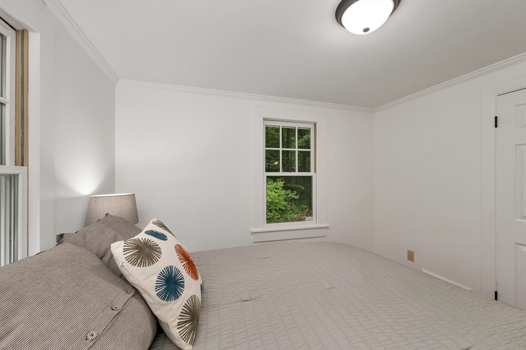 104 Kensington Road Hampton Falls, NH 03844 - Photo 29 of 42 a bedroom with a bed and window