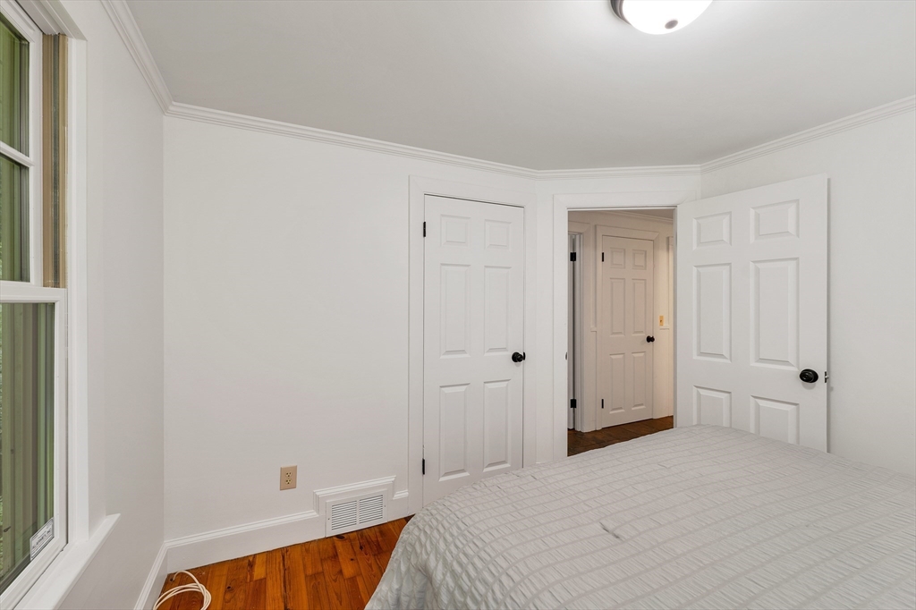 104 Kensington Road Hampton Falls, NH 03844 - Photo 31 of 42 a spacious bedroom with a bed and a window