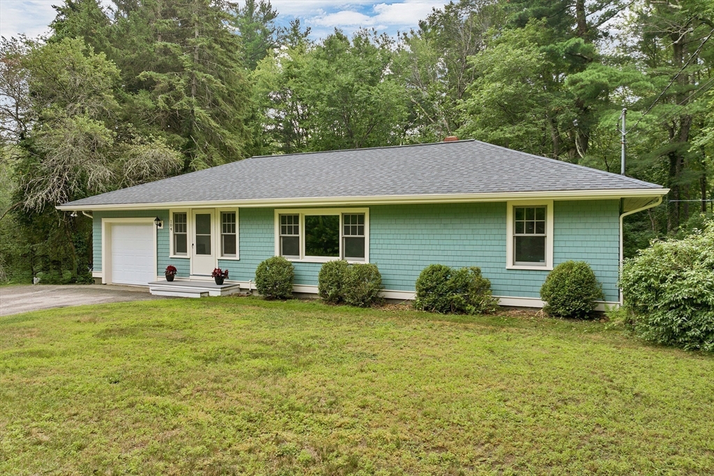 104 Kensington Road Hampton Falls, NH 03844 - Photo 33 of 42 a view of a house with a patio and a yard