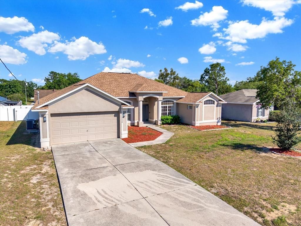 4400 Dior Road Spring Hill, FL 34609 - Photo 34 of 37 a front view of a house with garden