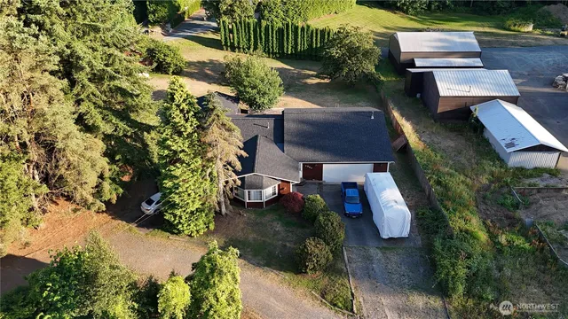 an aerial view of a house with garden space and street view