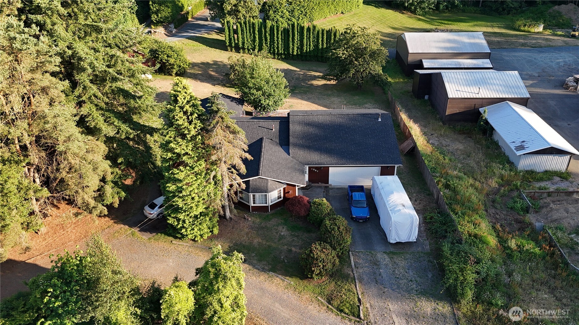 an aerial view of a house with garden space and street view